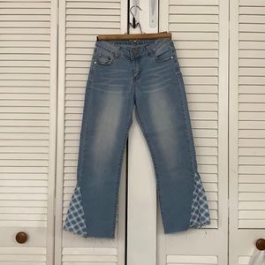 light wash jeans with plaid patter at the ankles